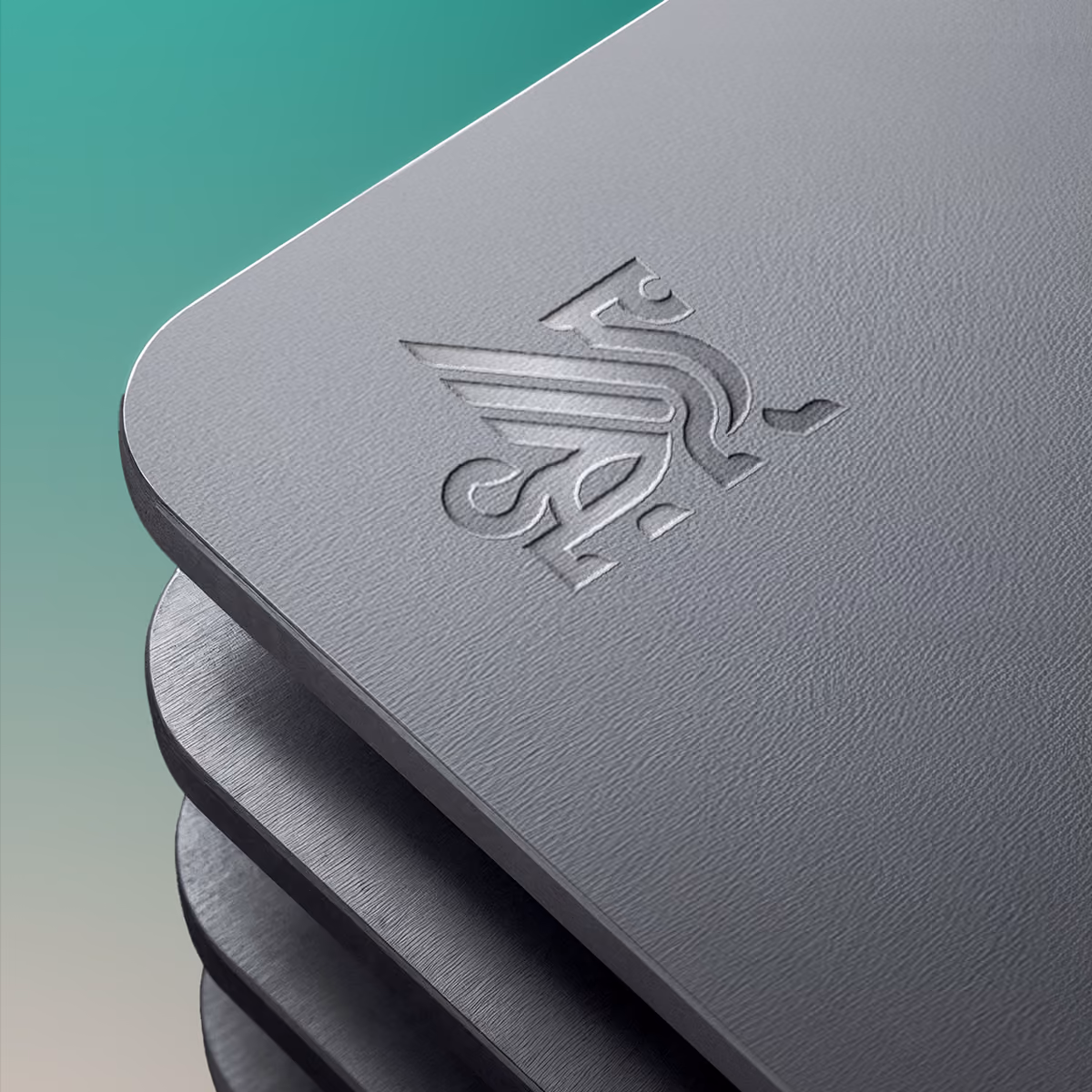 Close-up of stacked rectangular metal plates with rounded corners and an embossed abstract logo resembling a stylized bird or wing on the top plate, set against a gradient green background.